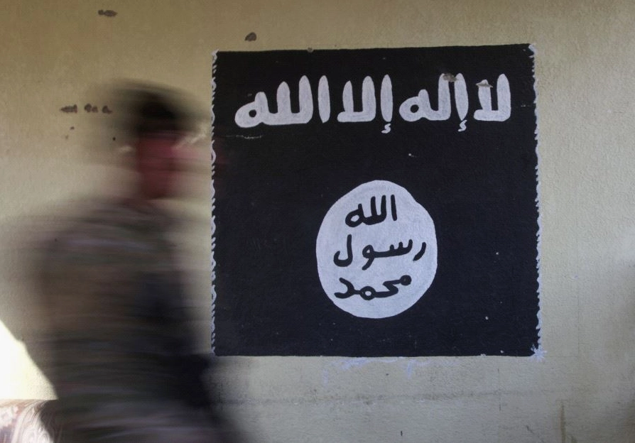 Một nhân vật lướt qua bức tường có vẽ biểu tượng lá cờ đen ám ảnh